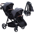 Dark grey tandem double stroller for newborn and toddler with reversible seats, adjustable canopy, 5-point harness, and large storage basket.