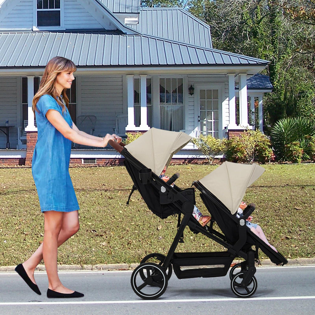 Double tandem stroller for newborn and toddler with reversible seats, safety harness, adjustable backrests, canopy, and storage basket.